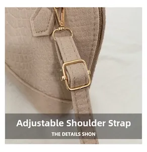 Detail of adjustable beige faux crocodile strap with premium gold metal hardware