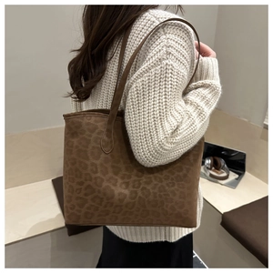 Macro shot of large leopard print tote bag in soft suede fabric for casual daily use