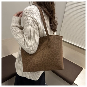Close-up of a vintage brown leopard print tote bag with soft suede texture finish