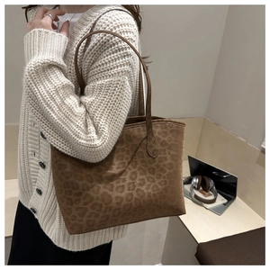 Leopard print tote bag styled with beige sweater in an office workplace setting