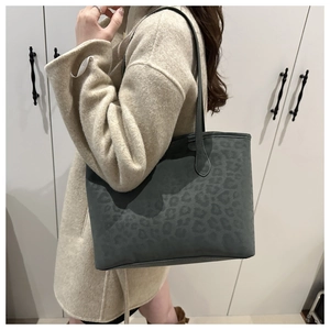 Detail view of large capacity dark grey leopard print tote bag with matte texture on shoulder