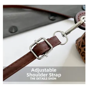 Detail of adjustable brown leather strap with silver buckle and leopard print accent