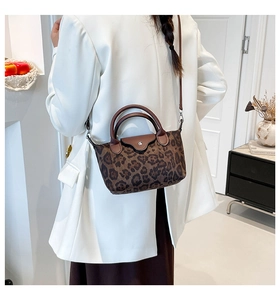 Detailed back view of leopard print shoulder bag worn by model in a minimalist room