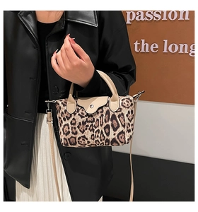Detail of leopard print nylon handbag with leather flap and adjustable shoulder strap