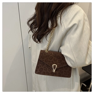Detail of dark brown leopard print shoulder bag with gold chain and metal buckle