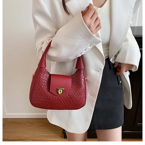 Detail of red woven leather shoulder bag with a gold-tone square twist lock closure