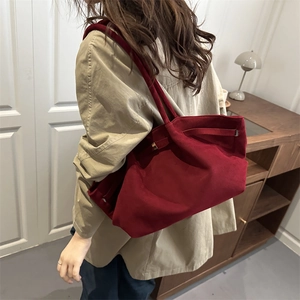 Elegant burgundy velvet tote bag for women showing a stylish shoulder carrying style