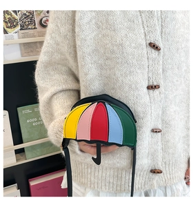 Detail of creative umbrella-shaped crossbody bag with colorful patchwork leather design