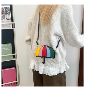 Detail of creative umbrella-shaped bag with colorful patchwork and black shoulder strap