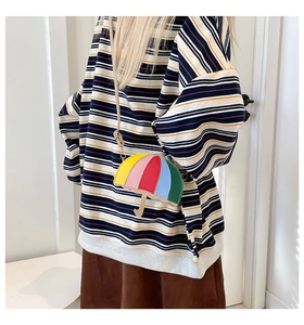 Detail of unique umbrella-shaped mini crossbody bag with colorful five-color stitching