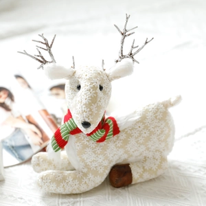 Detail of plush Christmas reindeer with white embroidery and festive striped scarf