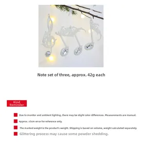 Close-up of glittery silver musical note ornaments for Christmas tree decorations