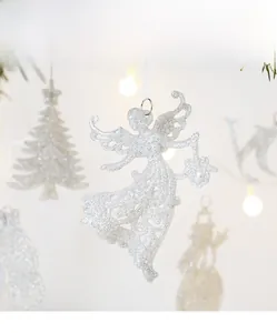 Macro shot of white glittery angel ornament with hollow design for Christmas tree