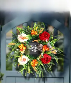 Detailed close-up of a floral wreath with blessed sign and leopard print bows on a gate