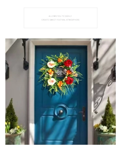 Detail of blessed floral wreath with red flowers and greenery on blue door