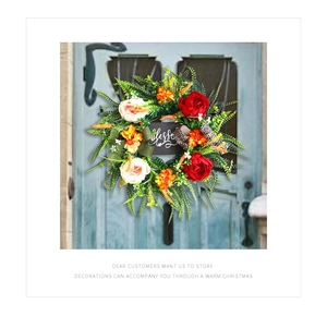 Detail of floral wreath with 'Blessed' sign, faux roses and leopard print ribbon