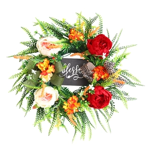 Artificial floral wreath with roses, peonies, and Blessed sign on white background