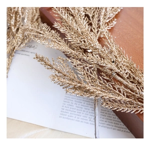 Detail of decorative golden glitter artificial pine needles for Christmas tree decor