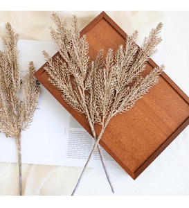 Detailed view of artificial golden glitter branches for Christmas tree and wreath decoration