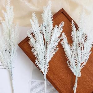 Three white glittered artificial pine branches for Christmas tree and wreath decoration