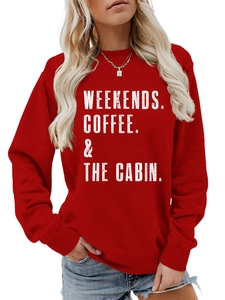 Detail of red crewneck sweatshirt featuring white weekends coffee the cabin slogan print