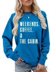 Detail of blue crewneck sweatshirt with white WEEKENDS COFFEE & THE CABIN printed text