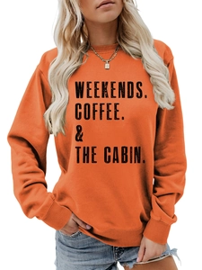 Detail of WEEKENDS COFFEE & THE CABIN slogan print on casual orange crewneck sweatshirt
