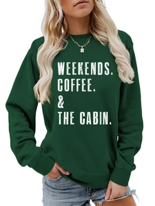 Detail of the white distressed lettering on the dark green crewneck cotton sweatshirt