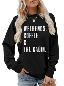 Detail of white graphic text on black crewneck sweatshirt showing fabric and print quality