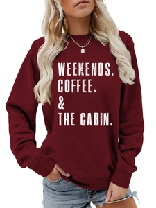 Close-up of distressed white text print on a deep red crewneck sweatshirt fabric