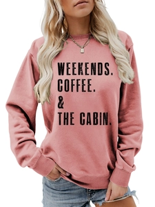 Detail of pink crewneck sweatshirt featuring WEEKENDS COFFEE THE CABIN text print