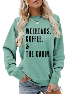 Detail of mint green crewneck sweatshirt showing ribbed cuffs and weekend coffee print