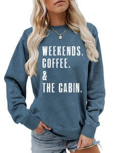 Close-up of ribbed cuffs and white text print on a blue round neck sweatshirt