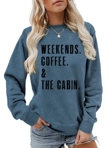 Close-up of Weekends Coffee The Cabin print on blue crewneck sweatshirt with ribbed cuff