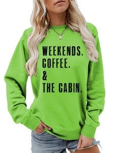 Detail of green crewneck sweatshirt featuring black WEEKENDS COFFEE and CABIN lettering