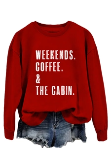 Close-up of Weekends Coffee The Cabin white graphic print on red cotton sweatshirt