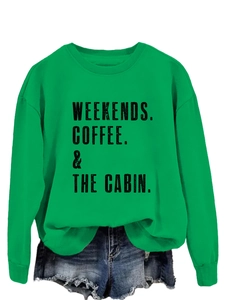 Detail of green crewneck sweatshirt featuring Weekends Coffee & The Cabin printed text
