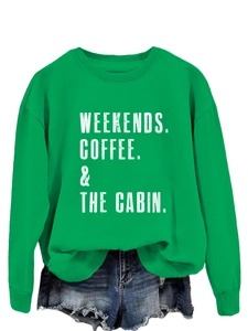Detail of green crewneck sweatshirt with white WEEKENDS COFFEE & THE CABIN print