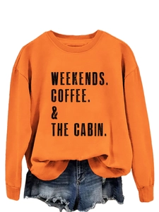 Detail of orange sweatshirt with weekends coffee cabin print and ripped denim shorts