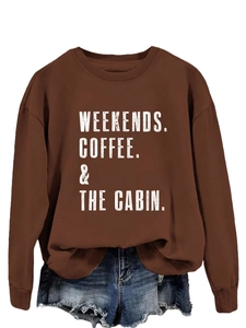 Close-up of Weekends Coffee The Cabin typography on brown crewneck sweatshirt