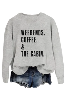 Detail of grey sweatshirt with Weekends Coffee The Cabin print and denim shorts