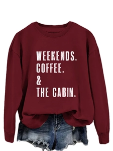 Close-up of Weekends Coffee & The Cabin slogan print on burgundy crewneck sweatshirt