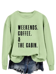 Close-up of mint green sweatshirt with WEEKENDS COFFEE & THE CABIN vintage print