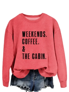 Detail of coral red crewneck sweatshirt with weekends coffee cabin text and denim shorts