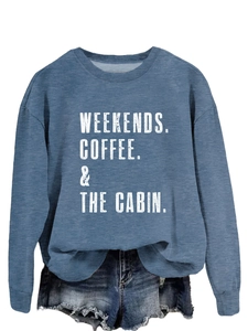 Detail of greyish-blue crewneck sweatshirt featuring white typography and ribbed cuffs