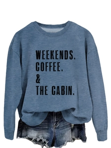 Detail of blue crewneck sweatshirt featuring Weekends Coffee The Cabin printed text