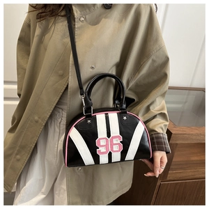 Detail view of Boston bag with pink 96 embroidery, metal star and detachable shoulder strap