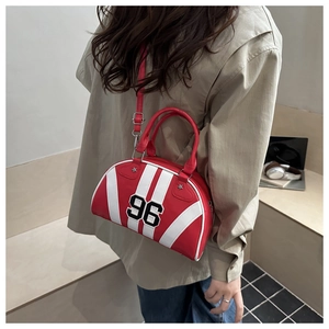 Close-up of red leather bowling bag with white stripes and number 96 embroidery