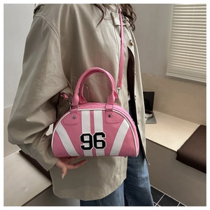 Detail of pink and white bowling bag with number 96 print and star-shaped rivets