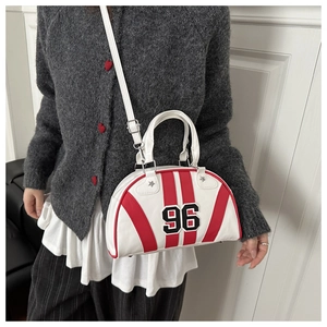 Detail of Boston bag with retro 96 patch, red stripes, and adjustable shoulder strap